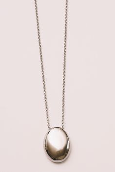 minimal necklace in silver pendant layering necklace in shiny finish on white background Oval Jewelry With Shiny Finish For Everyday, Everyday Oval Jewelry With Shiny Finish, Everyday White Gold Pendant Chain Necklace, Modern White Gold Necklace With Shiny Finish, Modern Everyday Teardrop Pendant Necklace, Modern Teardrop Pendant Necklace For Everyday, White Gold Sterling Silver Necklace With Oval Pendant, Minimalist Oval Stainless Steel Jewelry, Silver Teardrop Pendant Necklace With Cable Chain