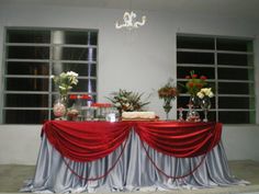 the table is covered with red and silver cloth