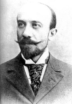 an old black and white photo of a man with a beard wearing a suit and tie