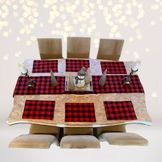 the table is set with red and black plaid placemats