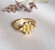 Bunch of grapes ring, gold plated ring, handmade ring, designer ring, vintage ring, dainty ring, delicate gold ring, gift ring for girls A delicate band decorated with a handmade bunch of grapes top, which was designed in a vintage style. Dimensions: The top size is 1.25x1 cm (0.5x0.4 inches) It is available in multiple sizes. Please choose at checkout. This delicate gold ring is available both in 14k gold plating and sterling silver and a beautiful gift ring for girls and bridesmaid. It can als Handmade Elegant Flower Ring For Gift, Unique Handmade Gold Stackable Rings, Unique Recycled Gold Rings For Gift, Handmade Rings In Recycled Gold For Gifts, Handmade Gold Flower Ring For Wedding, Handmade Yellow Gold Flower Ring For Wedding, Unique Brass Stackable Rings As Gift, Elegant Handmade Gold Flower Ring, Formal Handmade Brass Ring