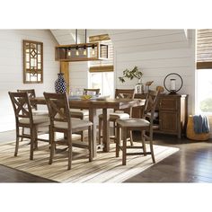 a dining room table with chairs and a bench