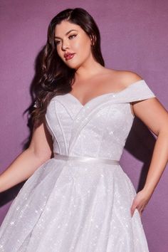 a woman in a white dress posing for the camera with her hands on her hips