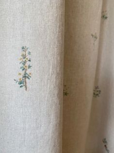 closeup of curtains with embroidered flowers on them