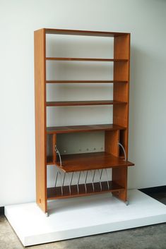 a wooden shelf sitting on top of a white platform