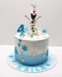 there is a frosted cake with snowflakes on it and the number four