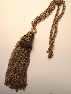 Vintage costume jewelry chained necklace with unique design. Weighs a few ounces. circa 1960. Victorian Metal Necklaces For Party, Victorian Metal Necklace For Party, Gold-tone Adjustable Chain Necklace For Evening, Evening Gold-tone Adjustable Chain Necklace, Formal Long Brass Chain Necklace, Vintage Jewelry With Adjustable Chain For Party, Vintage Party Jewelry With Adjustable Chain, Formal Costume Jewelry Chain Necklaces, Costume Jewelry Necklace With Adjustable Chain