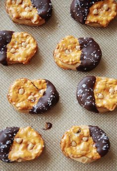 four chocolate covered donuts with peanut butter on top