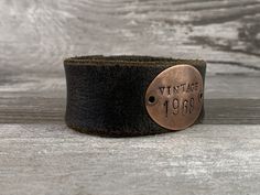 "Proudly proclaim that you are not \"old\" but you are a fine VINTAGE customized with your own birth year. Each of these cuffs is handmade to order, with a hand stamped copper blank on a distressed leather strap in your choice of black or brown. Each strap has been salvaged from a vintage leather belt and will show signs of wear and distress. Each piece is unique - no two re exactly alike! The distressing on the straps are not defects - they an intentional design element to add to the vintage vi Vintage Leather Belts, Birth Year, Vintage Birthday, Leather Cuffs Bracelet, Distressed Leather, Copper And Brass, Leather Belts, Leather Cuffs, Vintage Leather