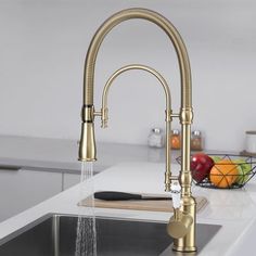 a kitchen faucet with water running from it's spout, and fruit in the background