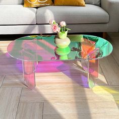 a glass coffee table with flowers on top