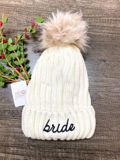 white knitted beanie with an attached soft Pom Pom, lettered with BRIDE in a black felt  These make a great gift for the Bride-to-Be!  ❄️❄️ Winter Bachelorette Party  One size fits most!  All hats are final sale.  Thank you SEW much for visiting Oak & Blossoms Etsy Shop! Where we love to make your accessories and gifts BLOSSOM! 🌸 Follow us on Instagram to see new arrivals, sales and giveaways! @oakandblossomboutique Little Ballerina, Winter Bride, Dance Bag, Perfect Pink, Black Felt, Girls Bags, Bridal Shower Gifts, Knit Beanie, Different Patterns