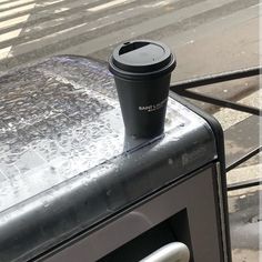 a coffee cup sitting on top of an oven