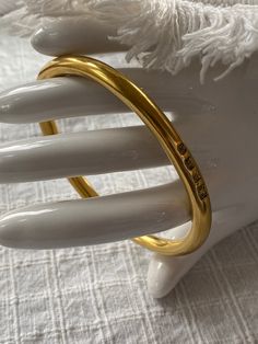 This is a lovely signed gold vermeil bangle bracelet, made in England. It is fully hallmarked , and in excellent, vintage condition. The bracelet is beautifully made, and weighs 60g. The bracelet measures 7 5/8 inches inside. It is perfect for a larger wrist. It is stylish and appropriate for a male or female. This bracelet was made in England in 1941. Multiple hallmarks. "14k gold vermeil over sterling silver. Impressed anchor and lion assay mark with maker's mark FR and capital letter script R Gold Bangle Stamped 14k As Gift, Vintage 14k Stamped Gold Bangle, Timeless Gold Cuff Bracelet For Wedding, Classic Gold Bangle Tarnish Resistant, Gold Hoop Bangle With Polished Finish, Classic Gold Bracelet In Brass, Timeless Gold Bangle With Polished Finish, Timeless Polished Gold Bangle, Gold Hoop Bracelet With Polished Finish