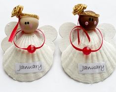 two little angel ornaments with name tags on them