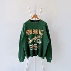 90s Green Bay Packers NFL sweatshirt/ L * PLEASE READ BEFORE PURCHASE * PLEASE consider the PHOTOS before making the decision * The images may DIFFER in appearance from the actual product because we took pictures under daylight.  * PLEASE send your PHONE NUMBER after your purchase for the shipping company to contact you X No returns X No refund Condition : 8/10 More details : stains (sleeve/ cuff)/ look at the pictures  Brand : Champion  Size : L Pit to pit/ Chests : 25/50 inches  Length : 27.5 Oversized Throwback Sweatshirt For Fall, 90s Oversized Sweatshirt With Letter Print, Oversized 90s Letter Print Sweatshirt, 90s Graphic Print Fall Sweatshirt, Throwback Letter Print Sweatshirt For Fall, 90s Long Sleeve Sweater With Letter Print, 90s Style Sweatshirt With Ribbed Cuffs, Retro Green Oversized Sweatshirt, Green Oversized Retro Sweatshirt