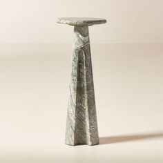 a marbled pedestal with two legs and a top that is shaped like a cone