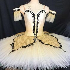 a white tutu with black trimmings on it