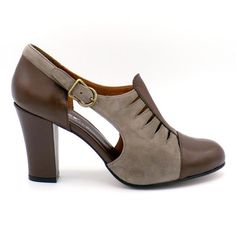 a woman's brown and tan shoe with two straps