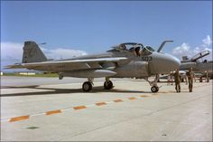 an air force jet sitting on top of an airport tarmac