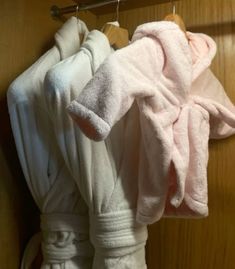 two robes hanging on a wooden door