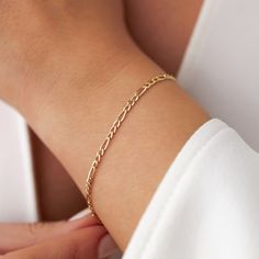 Our new simple and dainty Figaro chain bracelets, as always made in 14k solid gold. You can wear this bracelet with a free mind without worrying about water, perfume, or conditioner contact since real gold never tarnishes.★ Features of the Bracelet (this listing is for a single bracelet only)• Gold Kt: 14K Solid Gold (all pieces are stamped for authenticity)• Available Gold Color: Yellow Gold• Chain Width: 2.5 mm Single Bracelet, Solid Gold Bracelet, Water Perfume, About Water, Free Mind, Chain Bracelets, Figaro Chains, Figaro Chain, Yellow Gold Chain