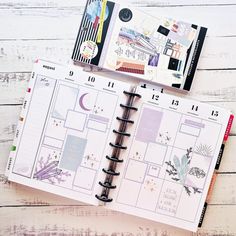 an open planner book sitting on top of a wooden table