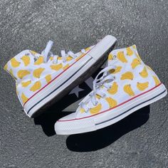 GO BANANAS with our Banana Bunches High Top Converse!  These white high tops have a repeating pattern on the outside and inside panels of both shoes.We buy each pair of shoes BRAND NEW. Each pair is made to order, please make sure you put in the correct shoe size before you check out. The paint is permanent and will never come off, fade away, or peel off. Made in the USA. This price includes everything: shoes, artwork, and shipping. Thanks for stopping by our Etsy shop! Please message me with an White Sneakers With Gum Sole For Summer, White Slip-on High-top Casual Sneakers, White High-top Canvas Shoes With Speckled Midsole, Casual White High-top Custom Sneakers, White Custom Sneakers For Summer Streetwear, Trendy White High-top Sneakers With Gum Sole, White High-top Casual Custom Sneakers, Trendy White High-top Sneakers With Speckled Midsole, Trendy White High-top Custom Sneakers