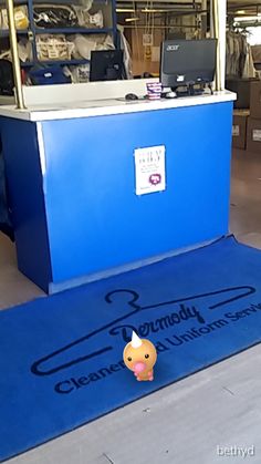 a blue carpet with a sign on it that says cleanmount university and an image of a person standing in front of the counter