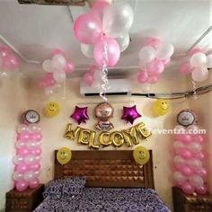 a bedroom decorated with balloons and heliums