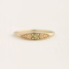 August birth ring This ring will be a very meaningful piece for those born in August . August's birthstone and birth flower are Peridot and Poppy. Greeny peridot and delicately carved poppy will shine and bloom forever. This dainty and slim signet ring is comfortable to wear all the time. This piece will be perfect gift for both to others and yourself. * Detail * Material : 14K solid gold, 18K solid gold, 925 sterling silver Color : Yellow gold, White gold or Rose gold(925 sterling silver is excluded) Stone : Natural Peridot(2.5mm) * Size * Top width : 3.7mm Shank width : 1.2mm Band depth : 2.4-0.9mm * Please check your ring size before ordering, Use this : http://www.onlineconversion.com/ring_size.htm We provide special package with some our business card, guarantee card, gift box. Please Subtle Promise Rings, August Birthstone Rings, September Birth Stone Ring, Boho Promise Ring, Engagement Rings Embedded Stone, Vintage Stone Ring, Gold Floral Ring, Simple Dainty Rings, Cute Class Rings