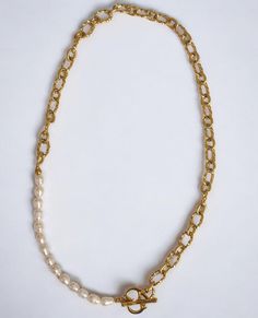 This versatile piece combines edgy style with sophistication, featuring a chunky textured chain and 14 freshwater pearls. The 19-inch length offers endless styling options, while the heart-shaped toggle clasp adds a sweet touch. Elevate any outfit with this bold and elegant necklace. Hypoallergenic (Lead and nickel free) Material: Stainless Steel, Freshwater Pearls Length: 19" (48cm) Hardware: Heart Toggle clasp Elegant Pearl Necklace With Chunky Chain, Pearl Necklace With Chunky Chain For Gift, Trendy Pearl Necklace With Chain, Everyday Pearl Necklace With Chain, Chunky Chain Pearl Necklace For Gift, Chic Pearl Chain Necklace With Adjustable Chain, Chic Everyday Chain Necklace With Pearl Charm, Gold Pearl Chain Necklace With Chunky Chain, Elegant Chunky Toggle Necklace In Metal