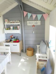 a child's playroom with white furniture and gray walls, painted in pastel colors