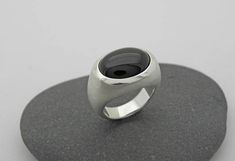 Elegant, simple silver ring with transversely aligned onyx in oval cabochon cut and beautiful dark black. Onyx oval 12 x 16mm All ring sizes are available. Please write your ring size in the comment field by checking out. On the following link, you will find the ring with a larger stone 20 x 15mm https://www.etsy.com/de/listing/228065410/grosser-onix-ring-in-silber-925?ref=shop_home_active_17 Minimalist Oval Cabochon Signet Ring For Formal, Minimalist Oval Cabochon Signet Ring For Formal Occasions, Modern Oval Cabochon Signet Ring For Formal Occasions, Modern Oval Cabochon Signet Ring As Gift, Modern Oval Cabochon Signet Ring For Gift, Modern Onyx Signet Ring With Polished Finish, Modern Sterling Silver Rings With Oval Cabochon, Modern Sterling Silver Ring With Oval Cabochon, Modern Sterling Silver Oval Cabochon Ring