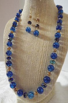 "Dress up any look with this tropical blue design that makes a perfect gift for anyone who loves blue! This necklace duo features 10mm blue quartz stones accented with gilded sapphire and topaz mercury rondells. The coordinating earrings are 2.5\" and ready to go.  The necklace is finished with a classic hook clasp. All orders come in a beautiful box ready to give along with a special \"thank you\" gift. Thank you for sharing my love of jewelry." Blue Necklaces, Handmade Ceramic Jewelry, Diy Jewelry Making Tutorials, Elephant Pendant Necklace, Blue Sapphire Necklace, Beaded Earrings Diy, Hand Painted Jewelry, Tropical Blue, Gemstone Beaded Bracelets