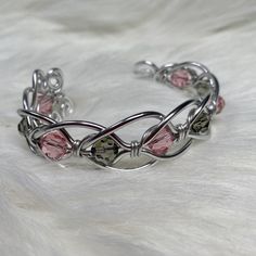 silver non tarnish Aluminum wire adjustable to fit a range of wrists light weight Swarovski crystals : smoke black & pink No modifications. Image shown is item you will receive.  Ready to ship Handmade wire wrapped jewelry by me! Black Wire Jewelry, Cool Wire Jewelry, Adjustable Silver Wire Wrapped Cuff Bracelet, Adjustable Wire Wrapped Crystal Bangle Bracelet, Adjustable Wire Wrapped Crystal Bangle, Adjustable Silver Crystal Bracelet Hand Wrapped, Diy Crystal Jewelry, Silver Wire Jewelry, Wrapped Bracelets