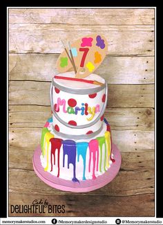 a birthday cake decorated with colorful icing and the number seven on it's top