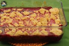 a casserole dish filled with crumbs on top of a green cloth