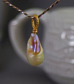 Lillia  Huge natural untreated color nucleated pearl by LusterWear #Pearl #Natural #UntreatedPearl #PearlJewelry #PearlPendant #PearlNecklace #Gold #Huge #HugePearl #NaturalPearl #Beautiful #Stunning #Freshwater #Nucleated #NucleatedPearl #FreshwaterPearl #Rare #Classy #Simple #ForSale #EtsyShop #EtsyJewelry #EtsySeller #Handmade #Etsyhandmade #SelfMade #MadeInUSA #Craft #art #Fashion #WomensFashion #WomensJewelry #WomensPearls #PearlLover #Gift #GiftIdea #Present #BirthdayPresent #Wedding Exquisite Gold Jewelry With Pearl Pendant, Exquisite Gold Jewelry With Pearl Charm, Exquisite Pear-shaped Pearl Drop Jewelry, Yellow Gold High Luster Pearl Necklace For Wedding, Briolette High Luster Pearl Necklace Gift, Yellow Gold Pearl Drop Pendant Jewelry, High Luster Briolette Pearl Necklace As Gift, High Luster Briolette Pearl Necklace For Gift, Yellow Gold Pendant Jewelry With Pearl Drop