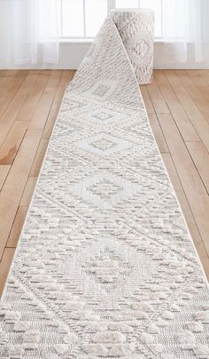 a white runner rug in front of a window