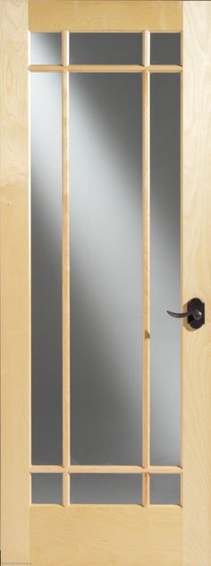 a wooden door with glass panels and a black handle on the front door, which is made of wood