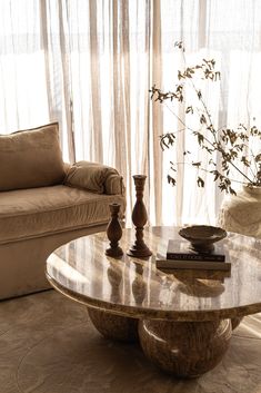 a living room with two couches and a coffee table in front of a window