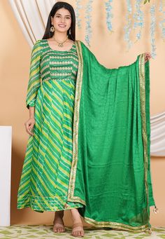 Pure Kota Silk and Art Silk Anarkali Kameez in Green Color. This Readymade Round Neck and Quarter Sleeve attire with Shantoon Lining is Enhanced with Leheriya Print, Zari ,Sequins and Gota Lace Work. Available with a Shantoon Churidar in Green and a Fancy Lace Border Faux Crepe Jacquard Dupatta in Green Color. The Kameez and Bottom Lengths are 52 inches respectively.   Do note: 1.)Accessories shown in the image are for presentation purposes only and length may vary up to 2 inches. 2.)Slight vari Anarkali Salwar Kameez With Pallu, Navratri Anarkali Set With Dupatta In Chinon, Festive Anarkali Set With Dupatta For Diwali, Festive Georgette Anarkali Set With Gota Work, Anarkali Style Floor-length Pista Green Palazzo Set, Pista Green Anarkali Kurta With Gota Work, Resham Embroidered Chinon Anarkali Set For Navratri, Festive Floor-length Anarkali Set With Zari Work, Anarkali Kurta In Pista Green With Dupatta