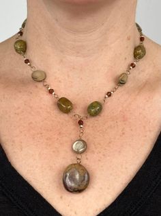 Handmade natural gemstone beaded necklace for person with a petite neck. This is an antiqued gold-tone single chain necklace comprised of polished light brown mother of pearl coin beads, faced brown plastic beads, natural polished green and brown agate gemstones. This beaded necklace has a pendant of a polished light brown mother of pearl coin beads and brown jasper gemstone, and is closed with a antiqued gold-tone toggle-clasp. This is a brown, mustard and hunter green handmade chunky necklace Handmade Stone Necklace, Funky Jewelry Necklaces, Earthy Necklace Stack, Handmade Brown Earthy Necklace, Brown Necklaces, Nature-inspired Brown Beaded Necklace, Adjustable Brown Beaded Necklaces Nature-inspired, Boho Necklace Layering, Nature-inspired Brown Jewelry With Gemstone Beads