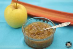 an apple sits next to a bowl of oatmeal