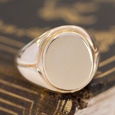 This vintage signet ring from the famed house Tiffany & Co. is big, bold, and gold - three of our favorite things here at JbyG. The 14kt gold is such a warm and buttery tone, and when worn, the ring feels like armor on the finger! The top of the ring is blank and ready to be engraved with a message or image of your choosing - or leave her blank and let your daily life leave its mark! 14kt Yellow Gold Size 9.75 & fully resizable Please see qualitative report for more information. Classic Domed Signet Ring Hallmarked, Classic Hallmarked Domed Signet Ring, Classic Domed Hallmarked Signet Ring, 14k Gold Domed Signet Ring With Polished Finish, Hallmarked Yellow Gold Domed Signet Ring, Classic Signet Ring For Anniversary With Polished Edges, Timeless Domed Signet Ring With Polished Finish, Classic Anniversary Signet Ring With Polished Edges, Classic Signet Ring With Polished Edges