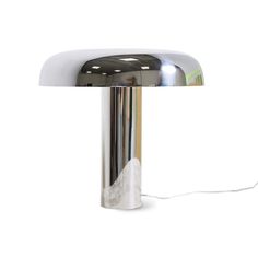 a chrome table lamp with a white background