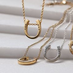 A refined necklace that showcases our bold new design, the Classique Horseshoe Pendant and Rolo Chain Necklace in 14K Gold on Sterling Silver exudes timeless elegance. Featuring a chunky yet graceful horseshoe pendant paired with a wide Rolo chain, this necklace captures light beautifully. The adjustable chain threads seamlessly through the horseshoe, secured by a sturdy lobster clasp. An ideal choice for those seeking professional yet stylish versatility, it blends EQ Elegance with modern charm Horseshoe-shaped Jewelry With Adjustable Chain, Gold Horseshoe Jewelry With Adjustable Chain, Gold Horseshoe Necklace With Adjustable Chain, Classic Horseshoe Gold Necklace, Everyday Gold Horseshoe Necklace, Elegant Gold Horseshoe Jewelry, Gold Horseshoe Necklace For Formal Occasions, Elegant Horseshoe Necklace For Everyday, Elegant Silver Horseshoe Necklace