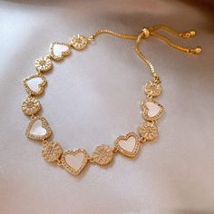 Description: Inlaid Natural Pearl Shell Chic CZ Heart Bracelet Specification:Size: 26 cmWeight: 15.6 g/pcsMaterial: 24k gold, copper, cubic zirconia, natural pearl shellColors: gold Add a touch of ocean chic to your style with our Inlaid Natural Pearl Shell Bracelet. The 24k gold CZ heart charm adds a romantic touch to this unique piece. Perfect for any occasion! 🌊💕✨ Luxury Elegant Gold Heart-shaped Bracelet, Luxury Gold Heart-shaped Bracelet, Elegant Heart-shaped Pearl Bracelet With Charm, Handmade Gold Shell-shaped Bracelets, Gold Heart-shaped Pearl Bracelet For Valentine's Day, Winter Bracelet, Shell Bracelet, Pearl Shell, Real Pearls