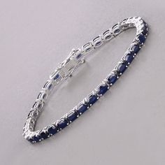 14k Gold Blue Sapphire Bracelet, Genuine Blue Sapphire Ovals Gold Bracelet for Women, Blue Sapphire Gold Tennis Bracelet, Gift for Her Celebrate the elegance of September with this luxurious 14K white gold tennis bracelet, featuring 7.48 carats of genuine oval blue sapphires. The deep blue sapphires, September's birthstone, are beautifully set in white gold, creating a striking and sophisticated piece. Designed with a secure box clasp, this bracelet offers both beauty and functionality. Perfect Luxury Blue Sapphire Bracelets, Blue Diamond Bracelet For Formal Occasions, Blue Oval Diamond Bracelet With Jewels, Luxury Blue Oval Diamond Bracelet, Formal Sapphire Oval Bracelets, Elegant Blue Jewelry With Jubilee Bracelet, Formal Sapphire Oval Bracelet, Blue Diamond Bangle Bracelet Fine Jewelry, Blue Diamond Bangle Fine Jewelry Bracelet